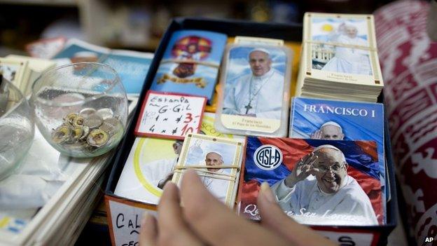 Artefacts with the image of Pope Francis are displayed at a shop in Buenos Aires, Argentina, (12 March 2014) a day ahead of the first anniversary of his election as pope