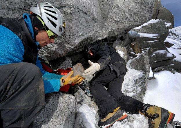 Stephane Dan and Alexandre Pittin find a piece of quartz in a cavity in La Dent du Geant, Mont Blanc