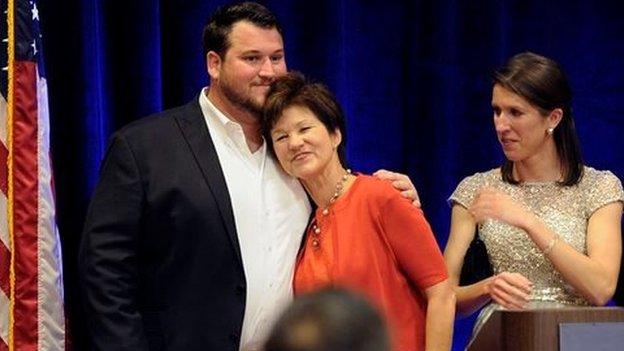 Democrat Alex Sink rests her head on her son's chest after conceding defeat in her congressional race on 11 March, 2014.