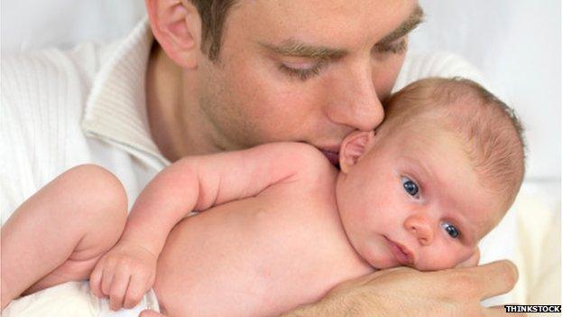 A father hugging his baby daughter