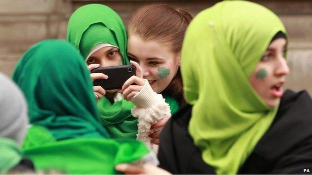 Girls in green hijabs in Trafalgar Square in London