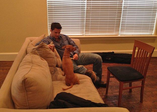 Ladar Levison on his sofa with dog, Princess