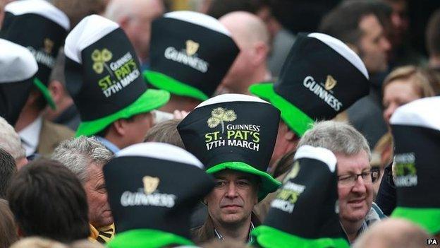 Racegoers at Cheltenham in their Guinness hats