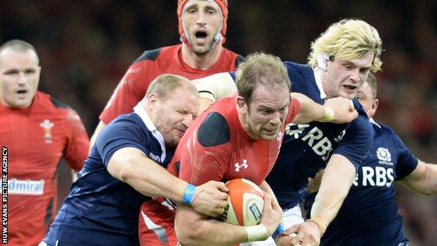 Two Scottish defenders grapple with Wales' Alun Wyn Jones