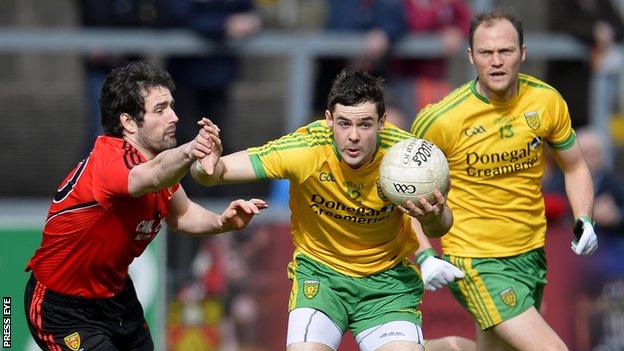 Down's Kevin McKernan challenges Odhran MacNiallais at Pairc Esler