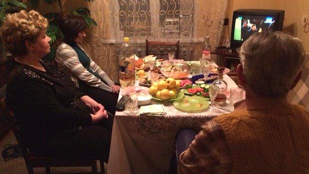 Irina, Sveta and Ivan watch the news on Ukraine's Channel One