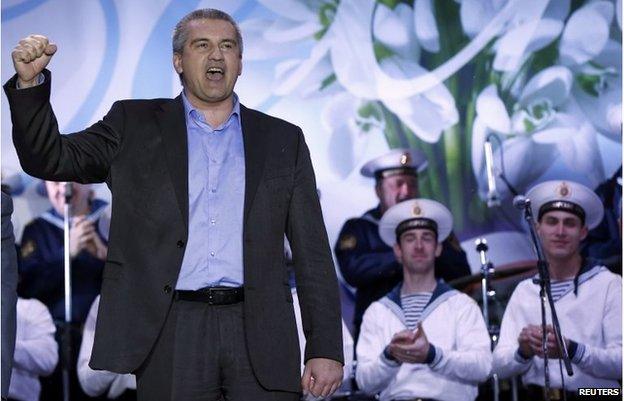 Crimean Prime Minister Sergei Aksyonov celebrates as the preliminary results of the referendum are announced on Lenin Square in Simferopol March 16