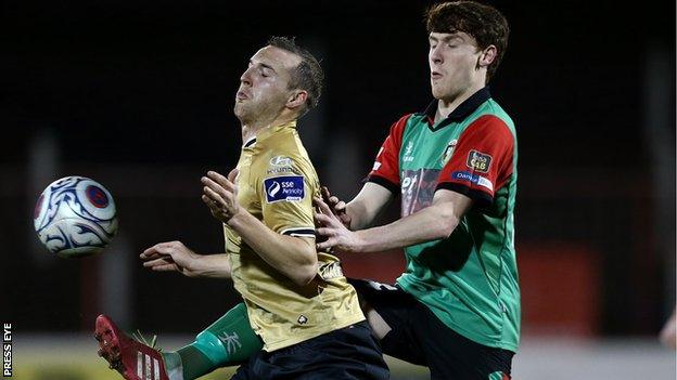 Karl Sheppard of Shamrock Rovers is challenged by Glentoran's Willie Garrett