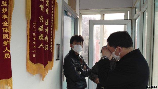 Friends of human right activist Cao Shunli stand in front of an intensive care unit where Cao is hospitalized as they are not allowed to go inside of the unit at a hospital in Beijing in this 1 March 2014 file picture