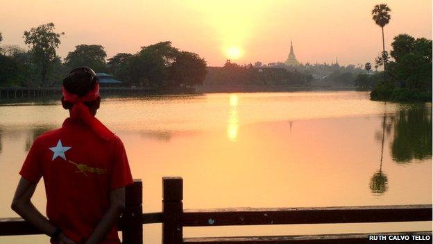 A man looks across a lake