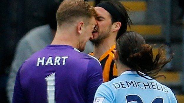 Manchester City keeper Joe Hart (left) and Hull City striker George Boyd clash during the game between their sides