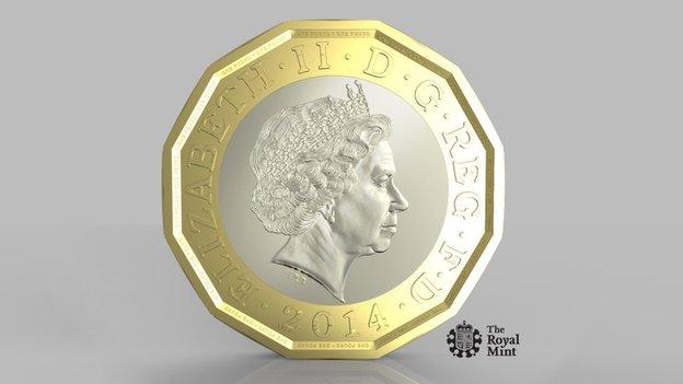 The new pound coin design. A twelve sided coin in gold, with a silver disc inset. The Queen features prominently.