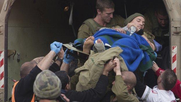 A wounded Israeli soldier is taken to a hospital after a bomb blast in the Golan Heights on 18 March 2014