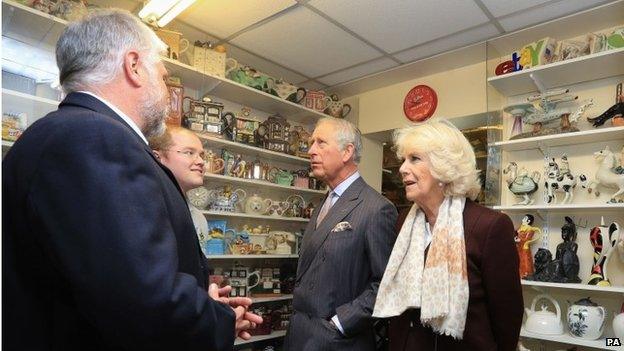 The Prince and Camilla are shown teapots on display in the museum of Teapot Island