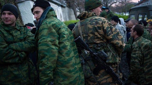 Armed Crimean defence forces stand outside naval training centre in Sevastopol. 19 March 2014