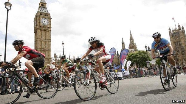 Riders pass the Houses of Parliament