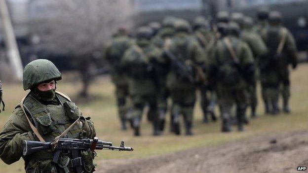 Russian soldiers patrol the area surrounding the Ukrainian military unit in Perevalnoye, outside Simferopol (20 Mar 2014)