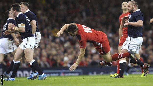 Stuart Hogg (left) sends Rhys Priestland flying