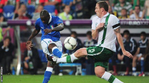 Richard Dunne tries to block a Mario Balotelli shot at the Euro 2012 game between Italy and the Republic of Ireland