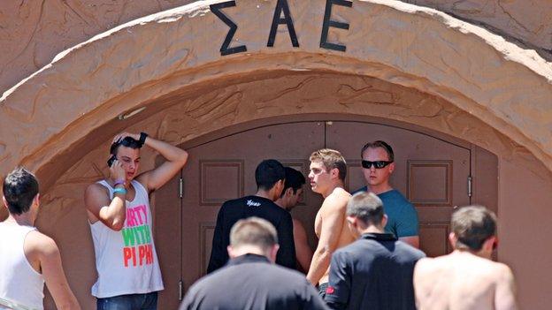 Students stand outside the Sigma Alpha Epsilon fraternity house on 20 April, 2012.