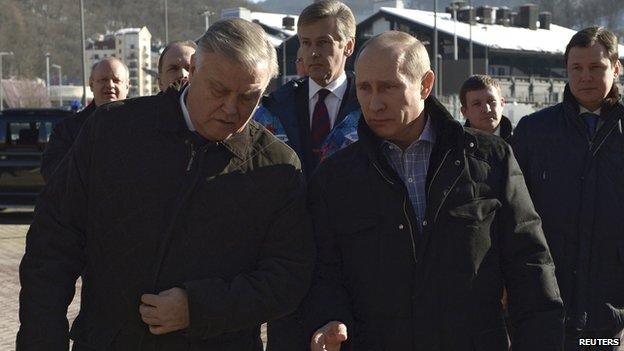 Russia's President Vladimir Putin (R) walks with Russian Railways President Vladimir Yakunin (L) during his visit to a recently constructed train station in Sochi (January 4, 2014)