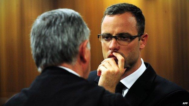 Oscar Pistorius consults his lawyer, Barry Roux, in the Pretoria courtroom