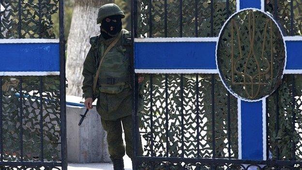 Pro-Russia soldier guards headquarters of Ukraine navy base in Crimea. 20 March 2014