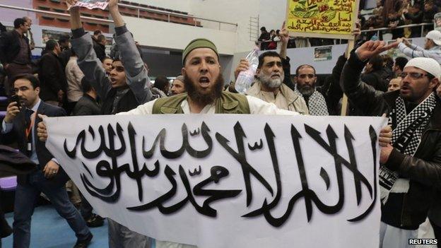 A protester holds up a sign at the rally on 21 March calling for the boycott of the Algerian presidential election