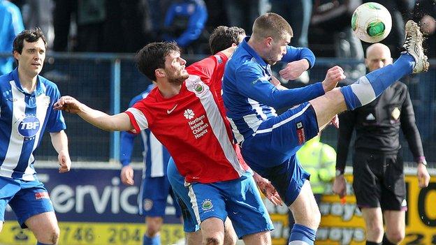 Linfield's Philip Lowry challenges his brother Stephen at the Coleraine Showgrounds