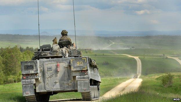 A British Warrior Armoured Infantry Fighting vehicle patrols down the live firing range in Grafenwöhr, Germany