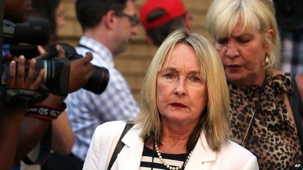 June Steenkamp, mother of Reeva Steenkamp, left, with unidentified woman leaves the high court in Pretoria, South Africa, Monday, 24 March 2014.