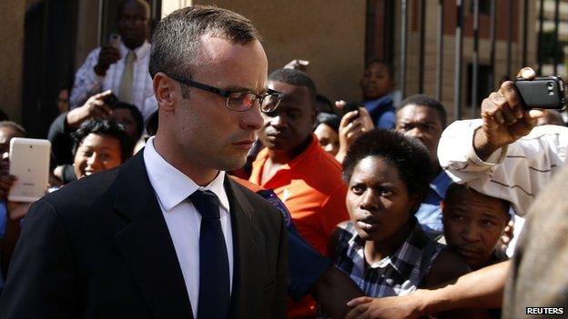 Oscar Pistorius leaves after his trial for the murder of his girlfriend Reeva Steenkamp, in Pretoria, on 24 March 2014