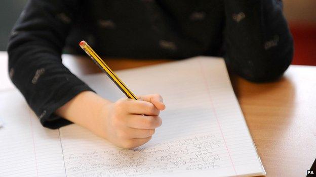 Child writing at school