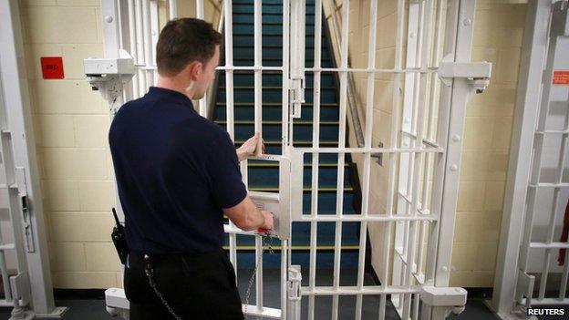 A prison guard locks a door at the Cookham Wood Young Offenders Institution in Rochester