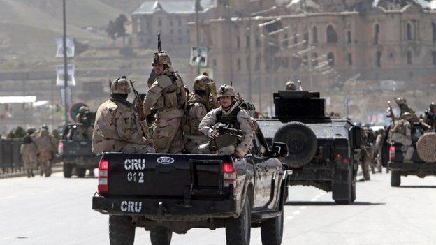 Afghan security officers arrive to the scene after two suicide bombers have struck near the home of candidate running for president, Ashraf Ghani Ahmadzai in the country's April 5 elections, in Kabul, Afghanistan, on Tuesday, 25 March 2014