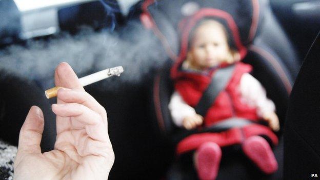 Lit cigarette in car with child