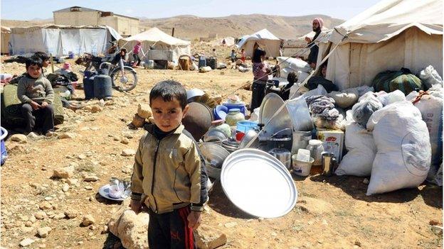 A child stands in a refugee camp