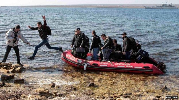 Crew members of a Ukrainian naval vessel come ashore in Donuzlav Bay, Crimea (24 March)