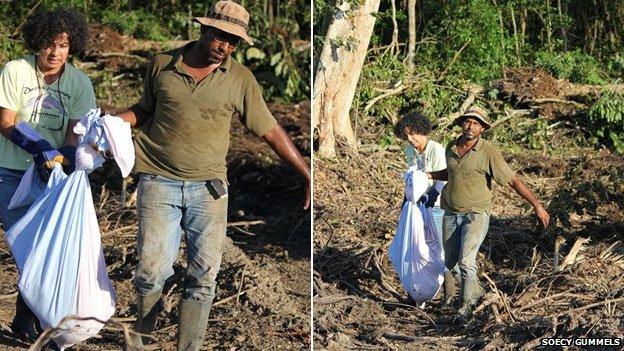 rescuers carry a sack of sloths