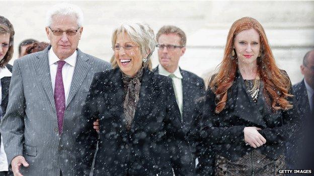 Hobby Lobby co-founders David Green (L) and Barbara Green (C) leave the U.S. Supreme Court after oral arguments in Sebelius v Hobby Lobby