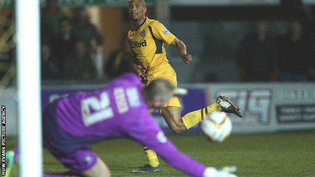 Bury goalkeeper Brian Jensen saves Newport striker Chris Zebroski's shot