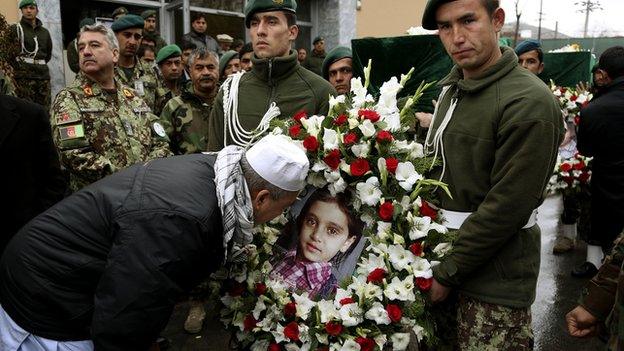 Shah Mohammad, Sardar's older brother attempts to kiss the picture of his niece Nilofar during the funeral ceremony in Kabul