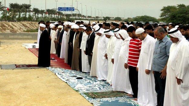 People pray at the former site of the Amir Mohammed Mohammed Barbagi Mosque