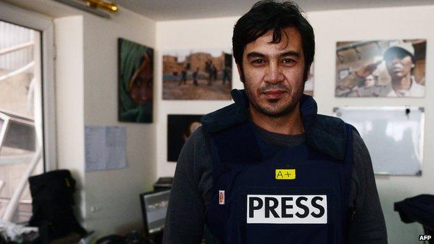 In this picture taken on March 20, 2014, Sardar Ahmad, 40, a Kabul based staff reporter at the Agence France-Presse (AFP) news agency poses for a photo at the AFP office in Kabul