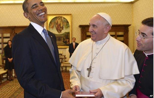 Pope Francis and President Barack Obama smile as they exchange gifts at the Vatican