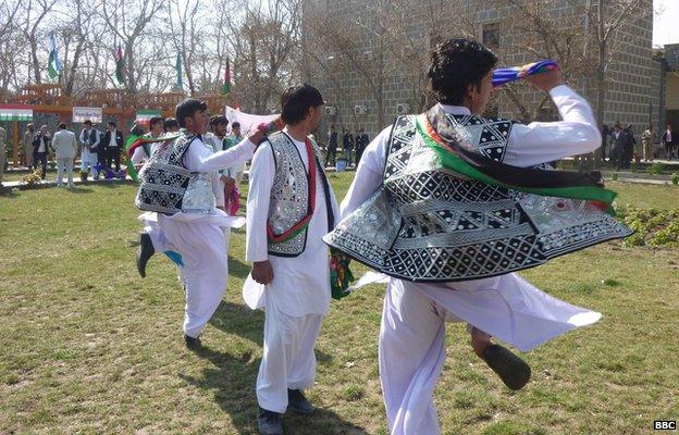 Afghan tribal dancers twirl, while wearing tribal waistcoats