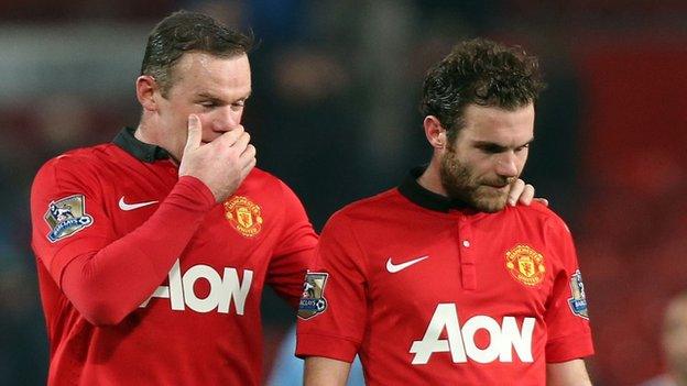 Wayne Rooney (left) consoles a dejected Juan Mata after Manchester United concede a third goal at home to Manchester City