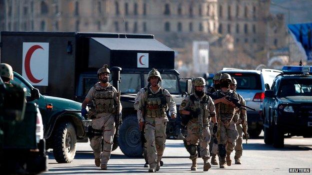 Afghan security forces near the election commission in Kabul following an attack by gunmen (25 March)