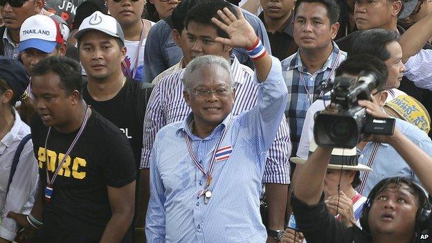 Thai anti-government protest leader Suthep Thaugsuban, centre, waves to supporters while making his way on the street during a mass rally in Bangkok, Thailand on 29 March 2014.