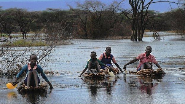 Children navigate flood waters in Kenya